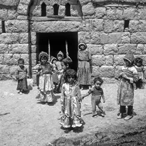 Children rocking in a house entrance, Amran, Yemen, Asia