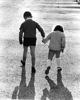 Children run hand in hand, England, Great Britain