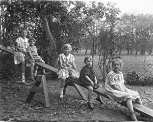 Five children on a seesaw, 1920s