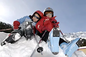 Two children wearing ski boots