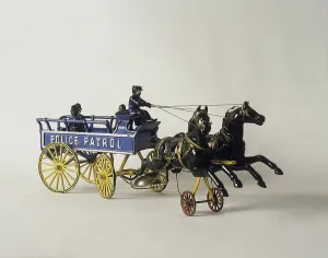 Childrens toys from the past. A cast iron toy made in USA with two horses pulling a police patrol wagon