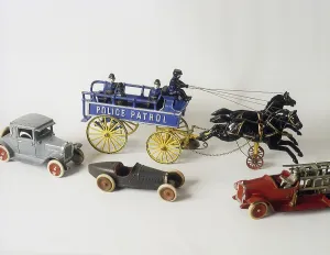 Childrens toys from the past. A cast iron toy made in USA with two horses pulling a police patrol wagon