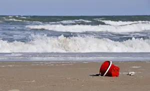 A childs sand bucket at the beach