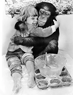 Chimpanzee hugs little girl, big friends