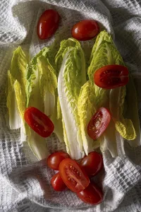 Chinese cabbage with cherry tomatoes on a white tea towel