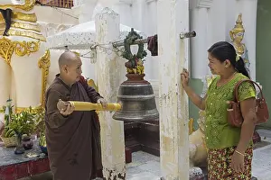 Chinese monk ringing bell at the Shwedagon Pagoda