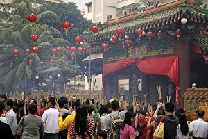 Category Buddhism Prints: Chinese New Year ceremony with incense sticks in front of the buddhist Kwam Im Tong Hood Che temple in Singapore