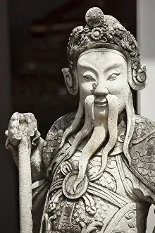 Chinese stone guardian statue close up in Wat Pho Buddhist Temple