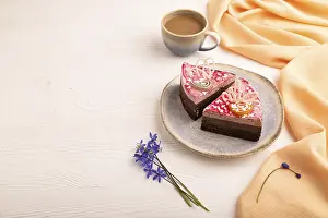 Chocolate cake on white wooden background and orange linen textile