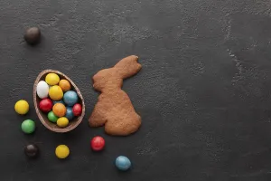 Chocolate easter egg filled with colorful candy bunny shaped cookie