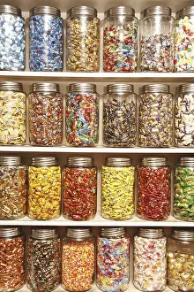 Chocolates kept in different glass jars on selves in shop