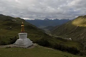 Chorten, stupa overlooking the Kyichu River valley near the Yerpa Drak Monastery in Lhasa with a Tibetan village