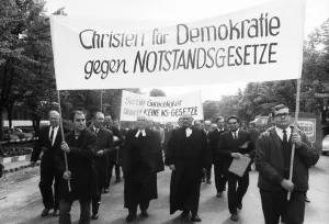 Several hundred Christians, among them church dignitaries in their robes