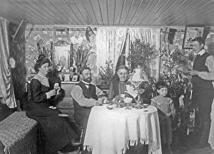 Christmas 1906. A family is celebrating christmas and is pictured here having coffee and eating biscuits. Sweden 1906