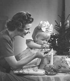 Christmas in the 1940s. A mother and her daughter is making nice christmas presents