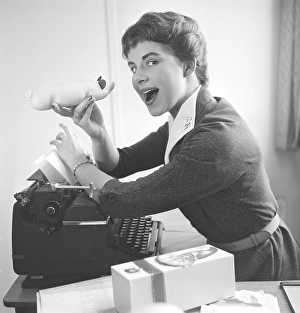 Christmas in the 1950s. A young woman is ready to taste the christmas marzipan pig