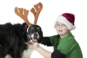 A Christmas boy and his reindeer black labrador