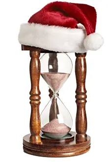Christmas is coming concept, hourglass with Santa Claus hat isolated on white background