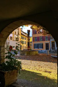 City Square and an Arch with Water Fountain and Cobblestone Street with House