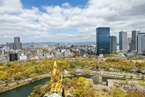 City view with skyscrapers and Osaka Castle Park with cherry blossoms