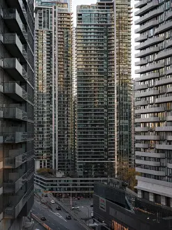 Cityscape with tall modern skyscrapers in the warm light of sunset in Toronto