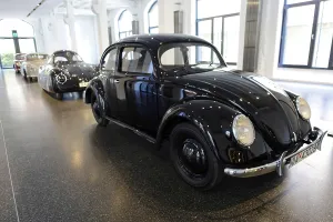 Classic black Volkswagen Beetle in a bright showroom