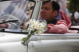 Classic car decorated with a bunch of daffodils