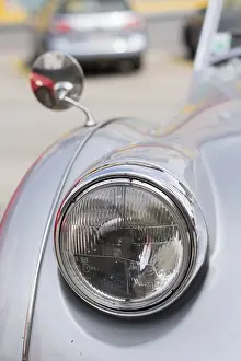 Classic car - Headlights and rear-view mirror of a classic car in view