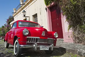 CLassic car in front of a house