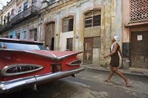 Classic car parked in a rundown street