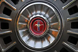 Detail of a classic car, wheel rim with emblem of a Ford Mustang Convertible