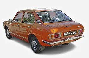 Classic orange Toyota Corolla parked