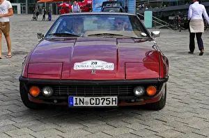 Classic red car seen from the front at a classic car event on the road