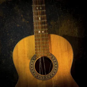 This classical guitar, resting against a dark brown backdrop