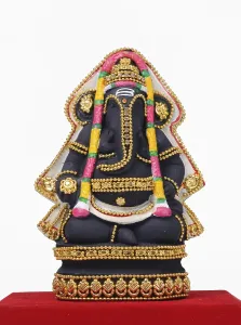 Clay statue of lord ganesh on red cloth