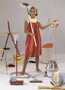 Cleaning day in the 1960s. A young woman is pictured with mops, vacuum-cleaner, buckets, cloths. Things and objects typically used in the 1960s when cleaning the house