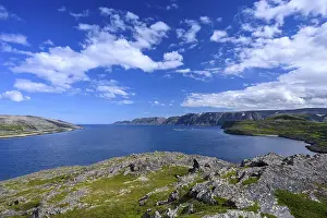 Clear blue sky over rough coastal landscape on Syltefjord with sea