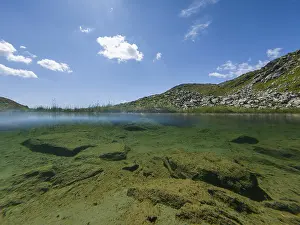 Clear mountain landscape with underwater view and sunny sky