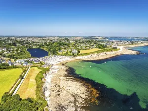 Cliffs over Swanpool Beach and Stack Point from a drone