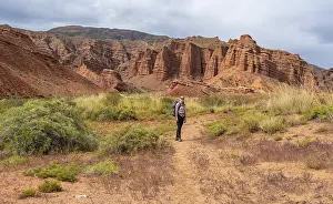 Climber in a canyon with a dry stream bed