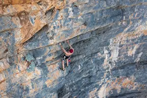Climber climbing on a rock face