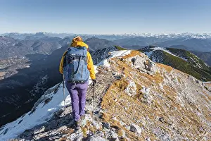 Climber walking along mountain ridge