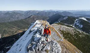 Climbers on the summit ridge with first snow in autumn