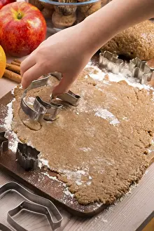 Close up little hands making the gingerbread cookies