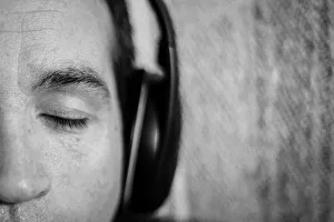 A close up of a mans face with his eyes closed