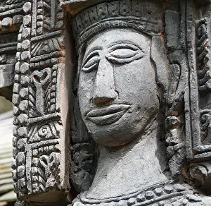 Close up shot of stone statue of a woman with a smiling face