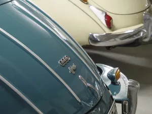 Close-up of two Audi classic cars in different colours with chrome details