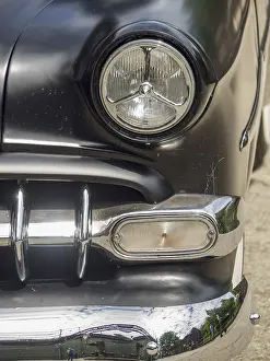 Category Oldtimer Prints: Close-up of a black classic car with focus on the headlights and chrome
