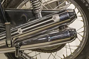 Close-up of a chrome-plated motorbike exhaust and tyre