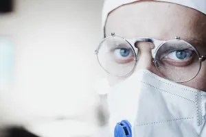 Close-up of a doctor with glasses and face mask